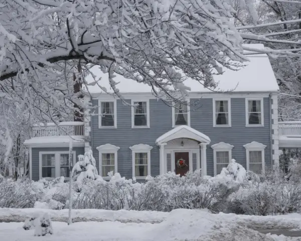 A house sits quietly under a blanket of fresh snow