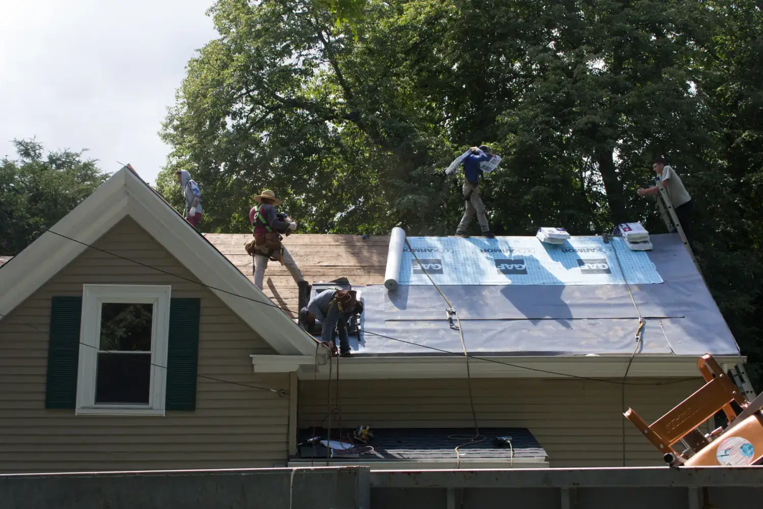 image of coastal roofing team in the process of installing a new roof