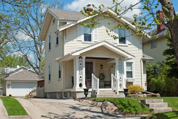 pale yellow house with vinyl siding