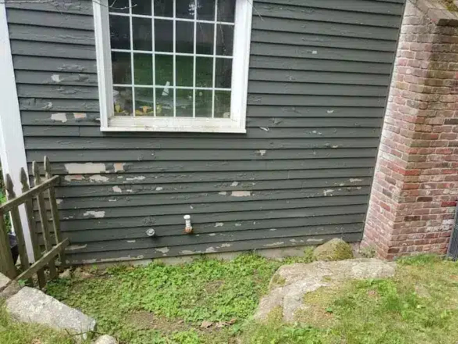 Peeling exterior siding showing why a home maintenance checklist should include checking for paint failure, moisture damage, and wood rot.