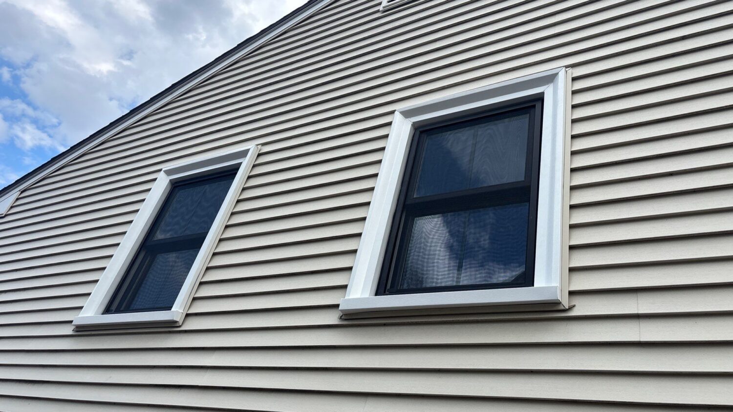 Black window frame replacement installed on modern Massachusetts home