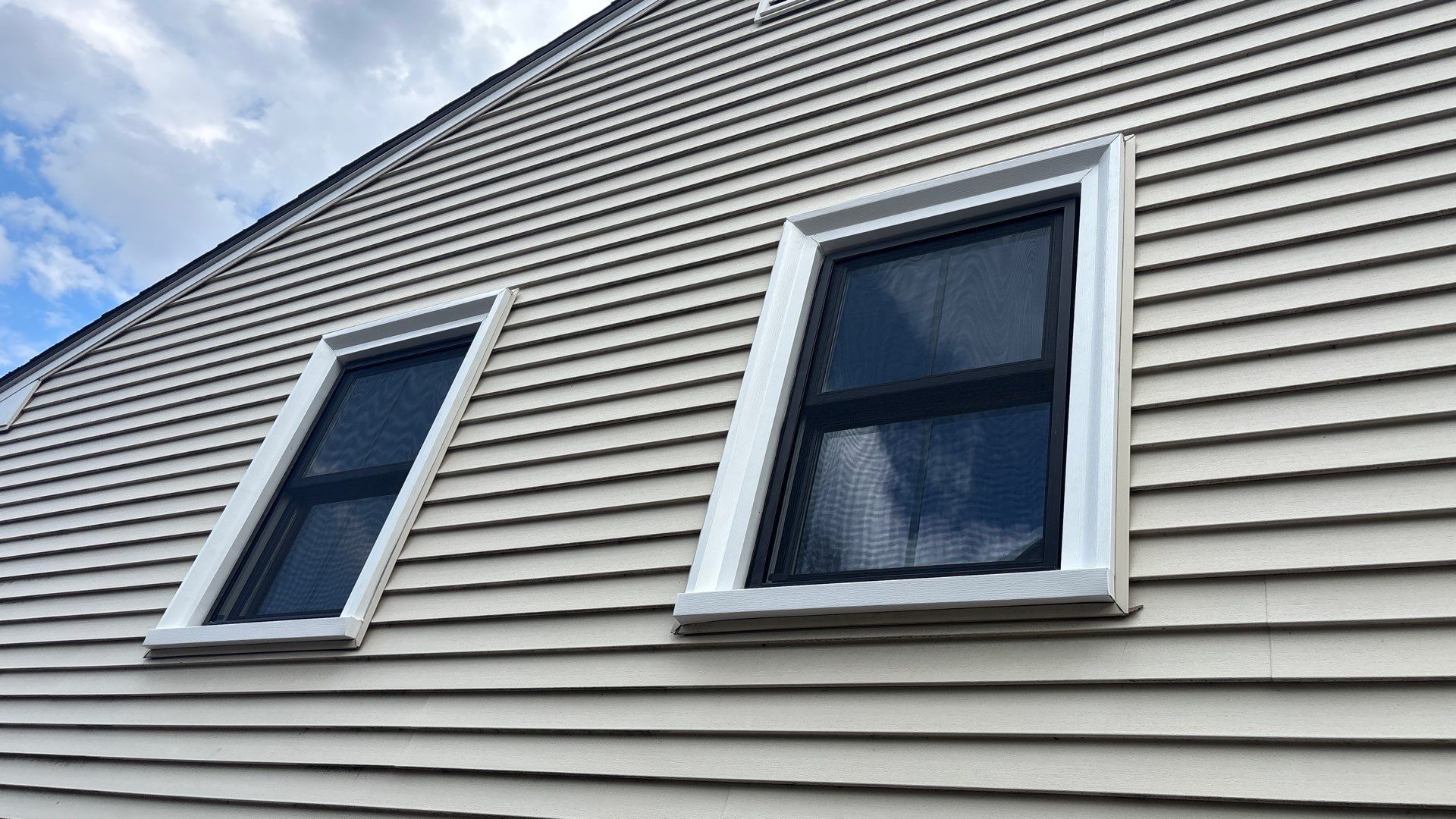 Black window frame replacement installed on modern Massachusetts home