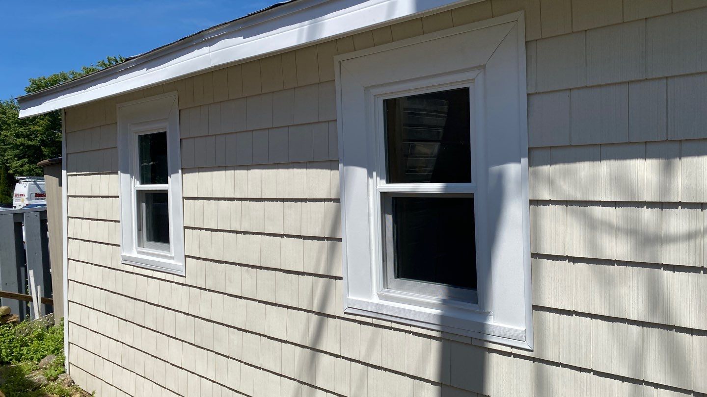 New vinyl replacement windows properly sealed and installed in Essex County Massachusetts home to prevent water leaks and improve energy efficiency - Coastal Windows Beverly MA
