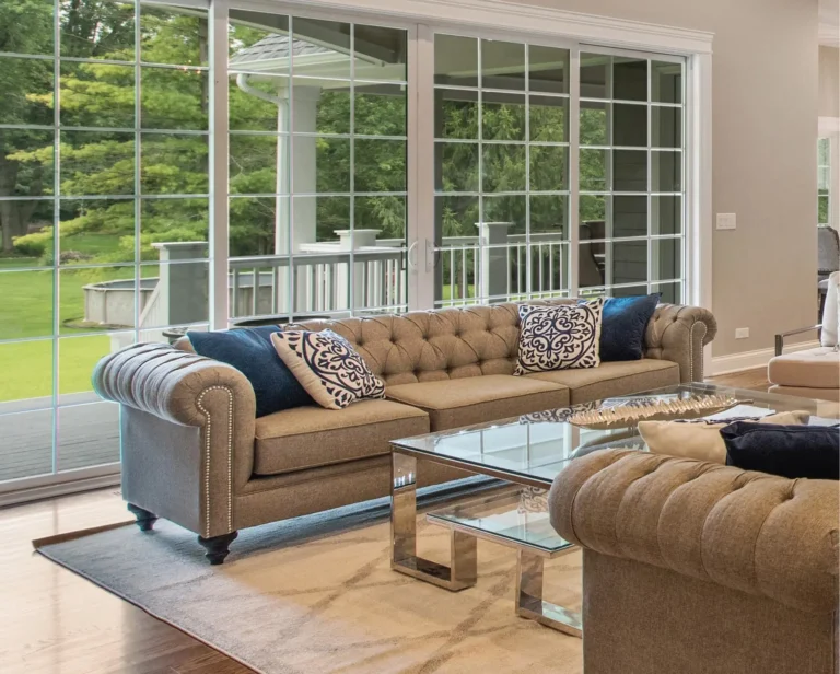 Large sliding glass doors and modern replacement windows help protect this living space from moisture intrusion and water damage. Windows are leaking water when seals, frames, or drainage systems begin to fail, making timely replacement essential for maintaining comfort and efficiency.