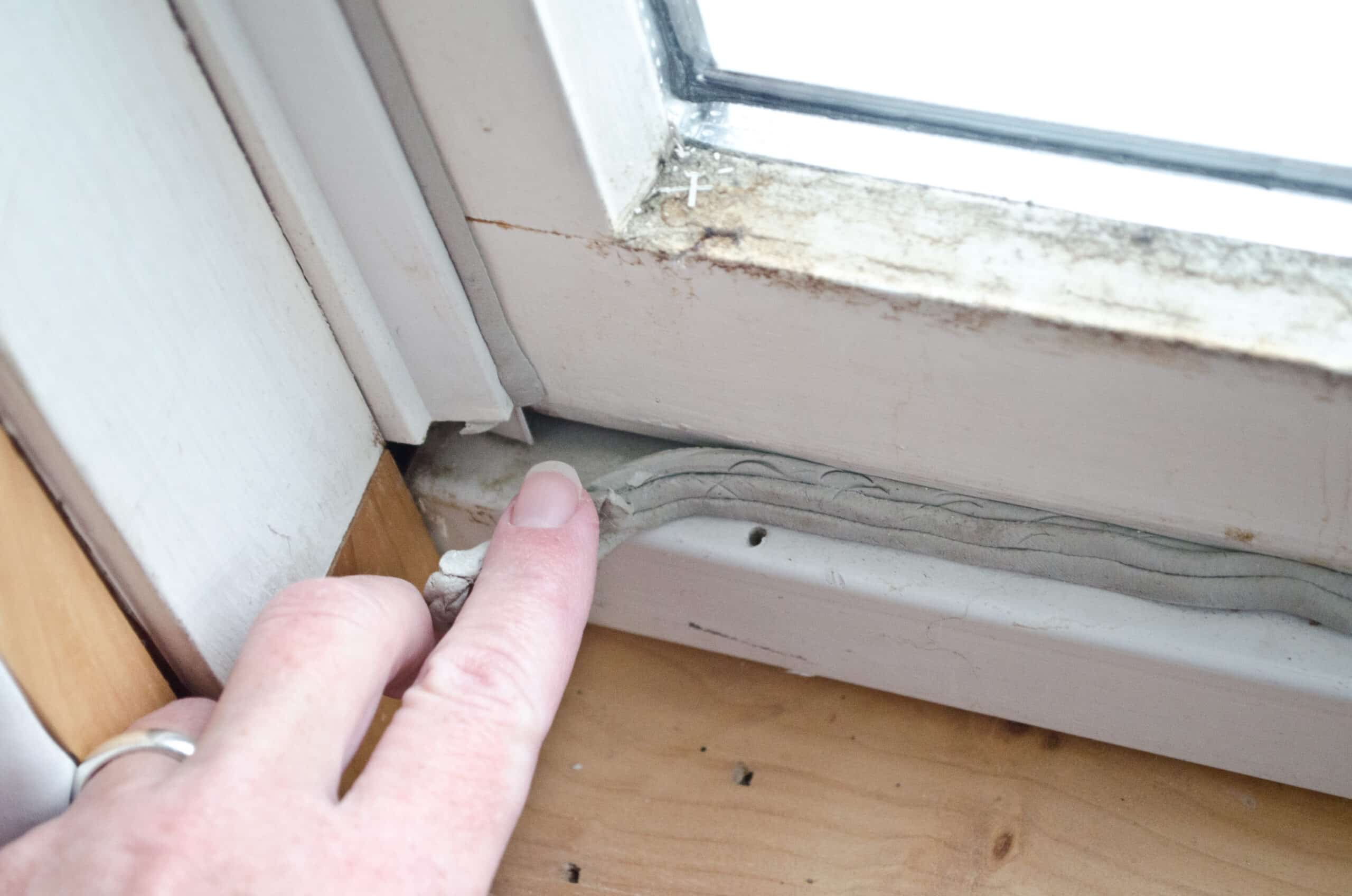 Close-up of deteriorated window caulking in Middlesex County Massachusetts home showing visible gap where water leaks into home - why are my windows leaking water - Coastal Windows inspection