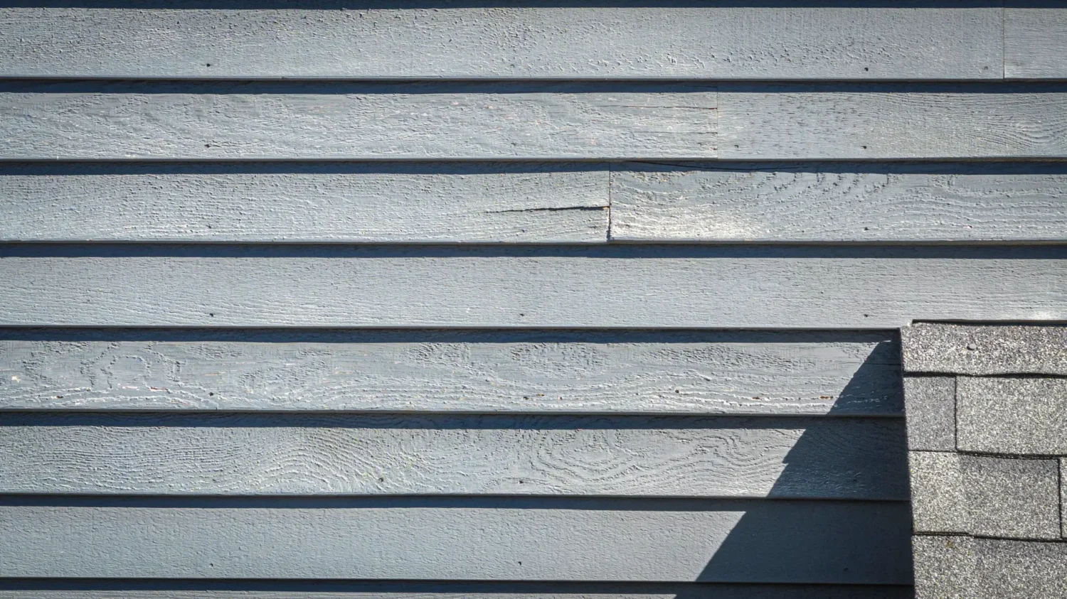 Weathered siding with visible moisture damage demonstrating issues beyond does vinyl siding fade.