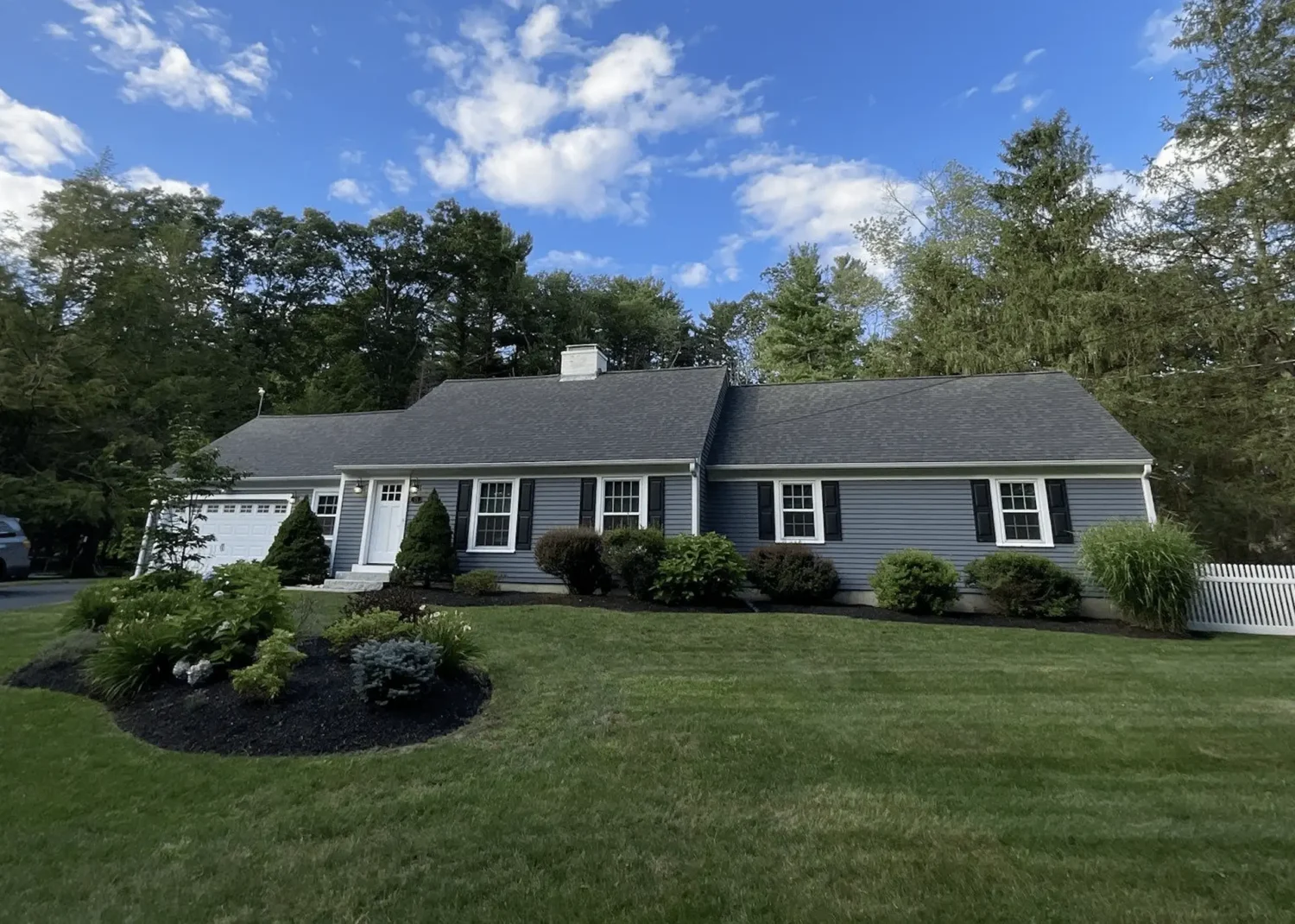Blue home with new vinyl siding showcasing lasting color for homeowners asking does vinyl siding fade.