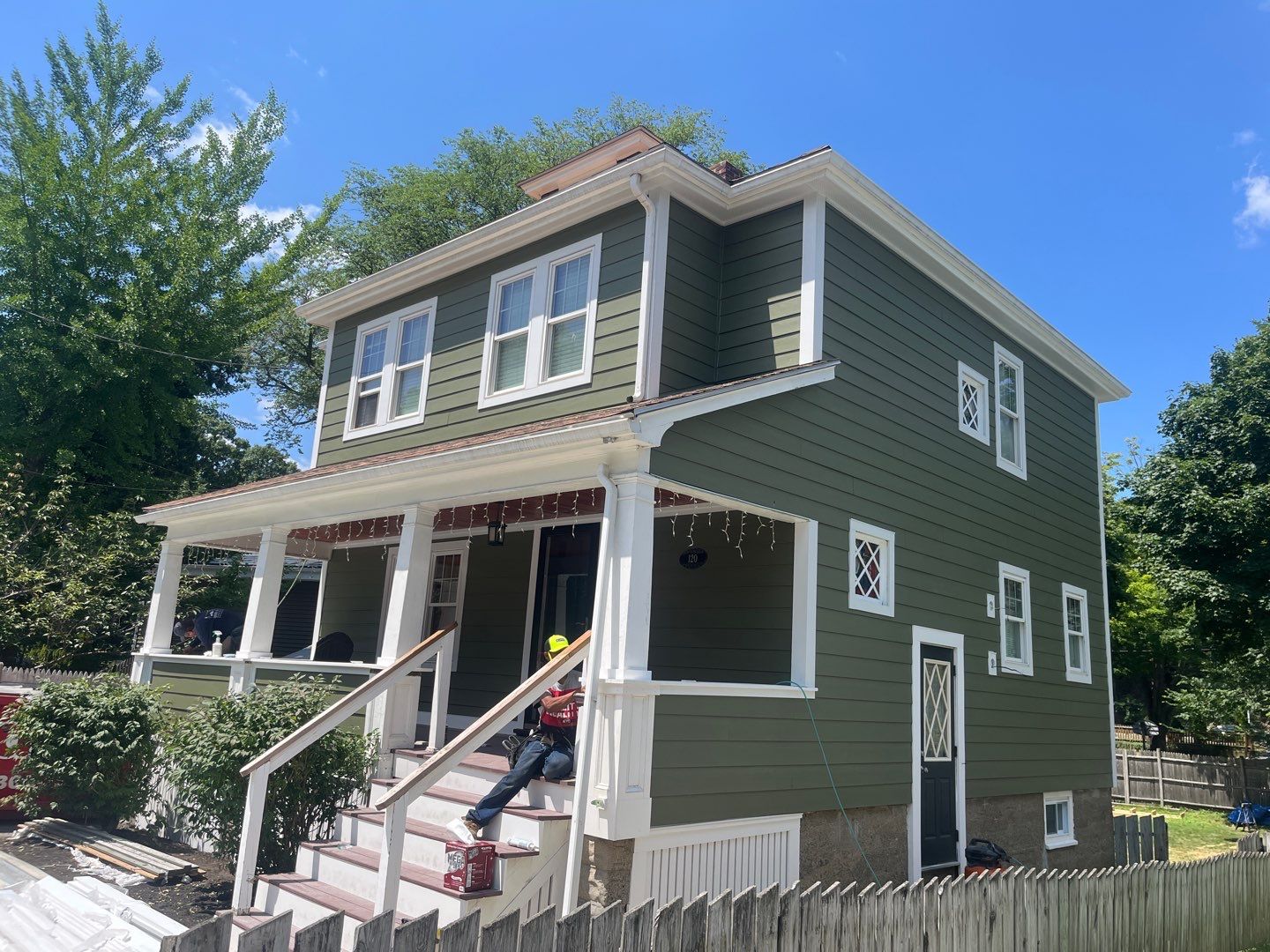 Green vinyl siding replacement in Medford, MA demonstrating long-lasting fade-resistant exterior protection.