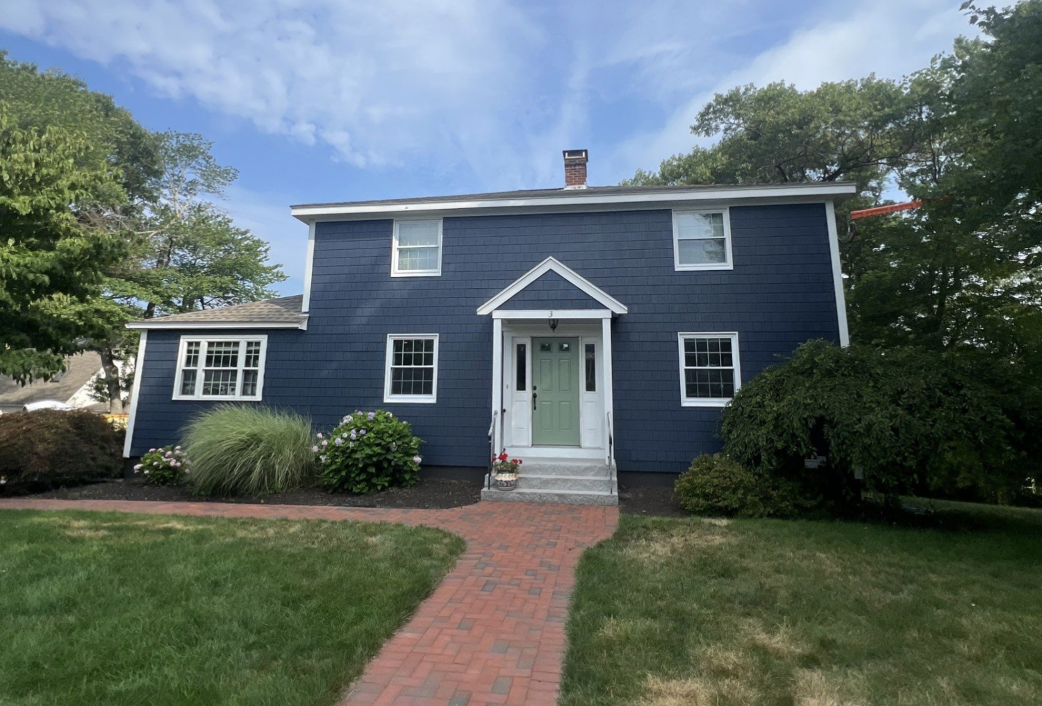 Blue house with green door and garden