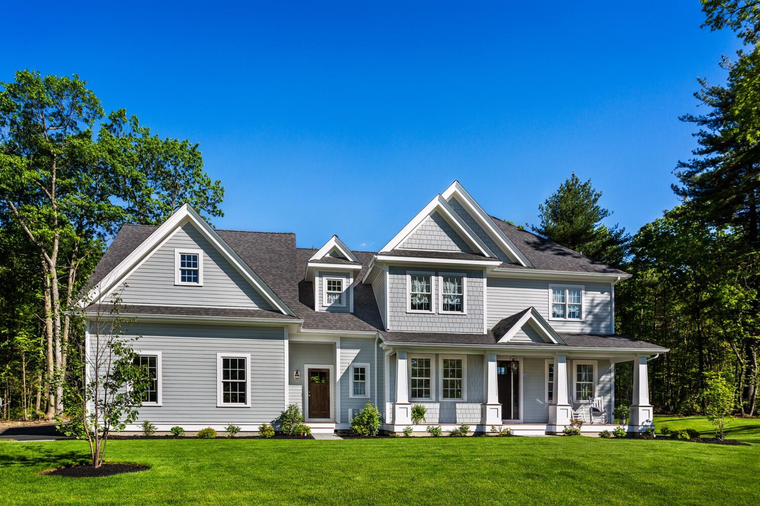 Gray vinyl siding installed on craftsman-style home in Marblehead MA by Coastal Windows & Exteriors