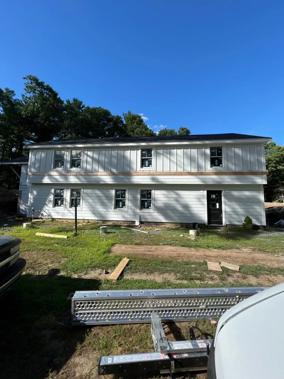 modern farmhouse with green exterior highlighting james hardie siding colors and curb appeal