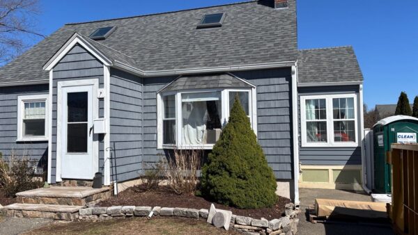 This home showcases energy efficient siding in a rich blue-gray finish that enhances curb appeal while helping improve insulation and reduce energy loss. The professionally installed siding provides lasting protection, durability, and a fresh modern appearance.