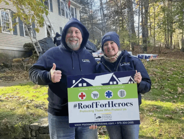 Coastal Windows & Exteriors honors a retired U.S. Coast Guard veteran with a Roofs for Heroes donated roof and presents a Coast Guard flag