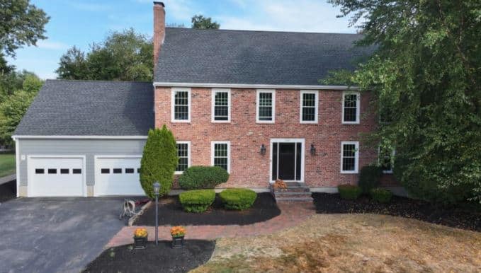 brick house with a dark gray roof in North Andover