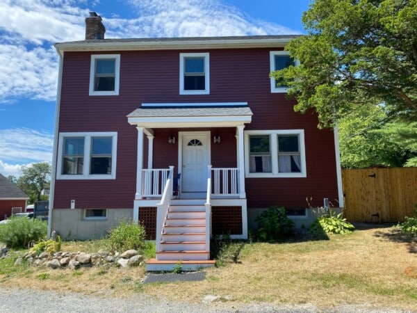 Side-by-side wood vs. vinyl siding transformation in Ipswich MA, North Shore, showcasing enhanced durability and curb appeal by Coastal Windows & Exteriors