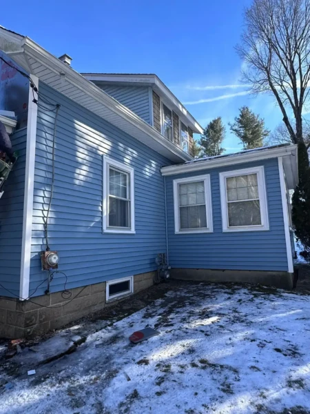 Blue vinyl siding installation in North Reading MA, Middlesex County, by Coastal Windows & Exteriors for a durable and energy-efficient exterior transformation