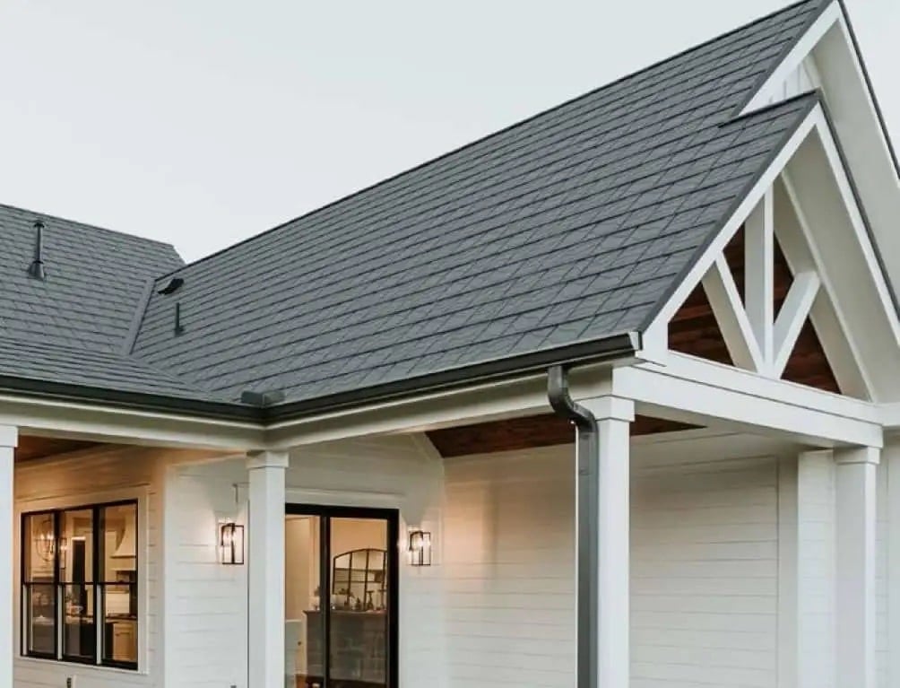 Modern home featuring dark architectural shingles, one of the most popular shingle colors for New England roofs.