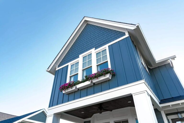 A blue house with james hardie siding in board and batten in West Newton, MA