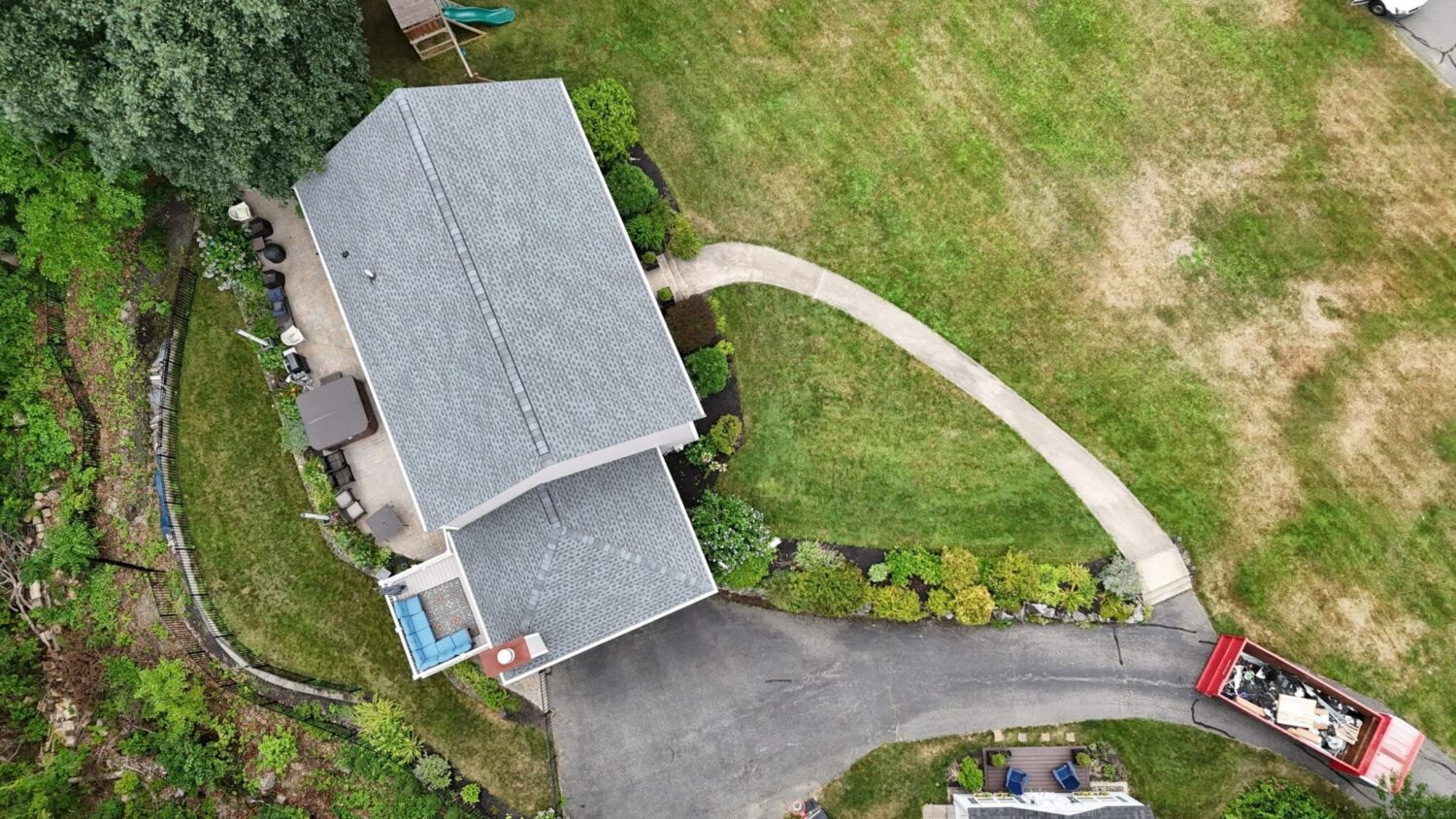 Aerial view of a completed asphalt roof installed after a professional roof repair project for long-lasting protection.