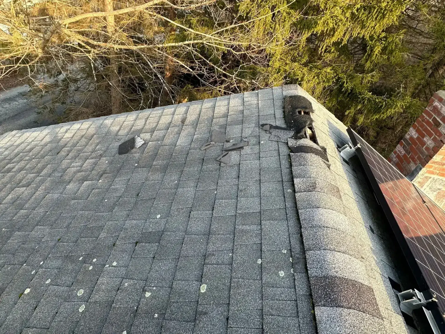 Missing and damaged shingles requiring immediate roof repair to prevent leaks and further storm damage.