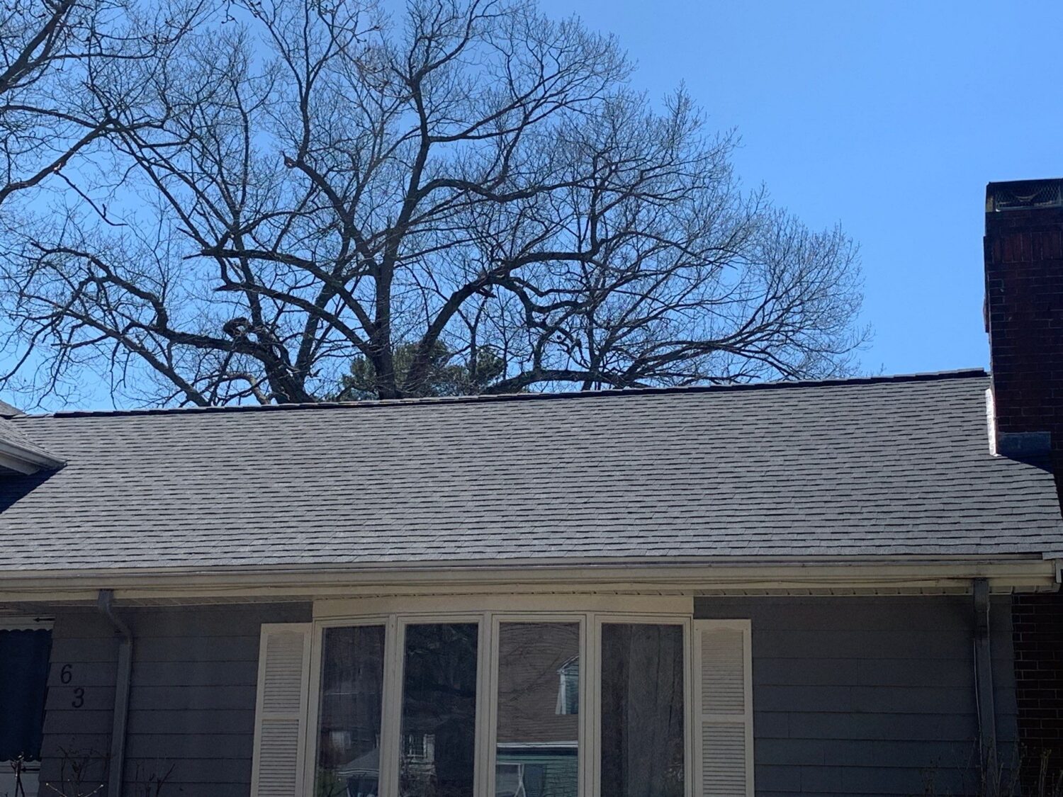 Asphalt shingle roof inspected during a roof repair to identify leaks, damaged flashing, and worn roofing materials.