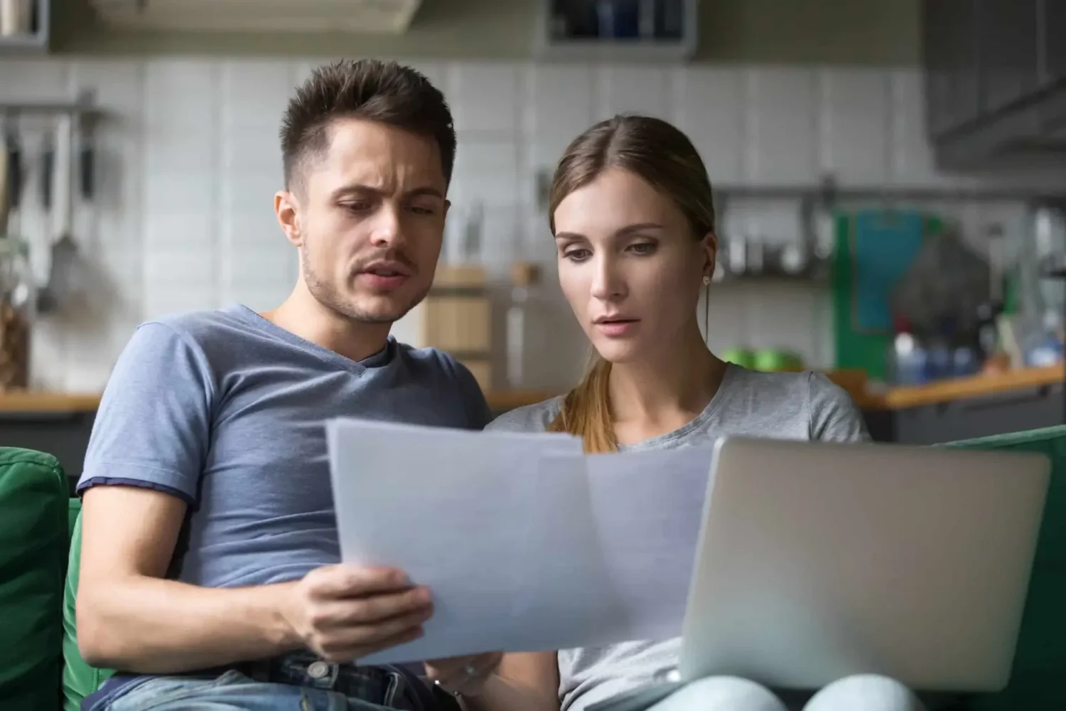 Homeowners reviewing high utility bills as part of a siding inspection checklist to determine whether deteriorating siding is causing energy loss.