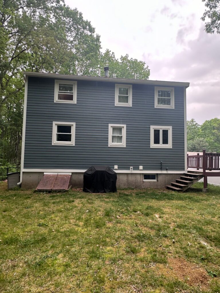 James Hardie siding installation Tewksbury MA showcasing Boothbay Blue plank siding with white trim accents