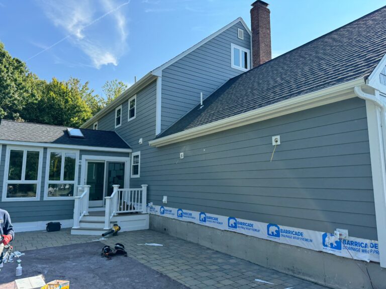 James Hardie siding contractors North Andover MA working on Colonial home
