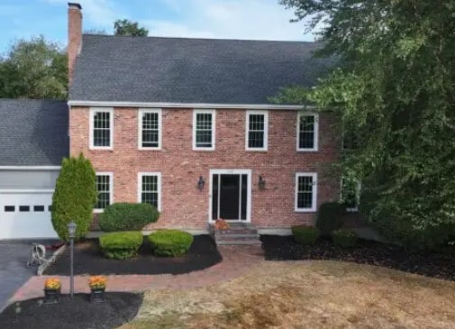 A two-story red brick house Salisbury Replacement Windows
