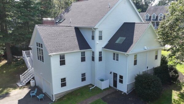 Blog explaining how summer weather—including inadequate ventilation, storm damage, and poor shingles—can lead to costly roofing issues over time in New England.