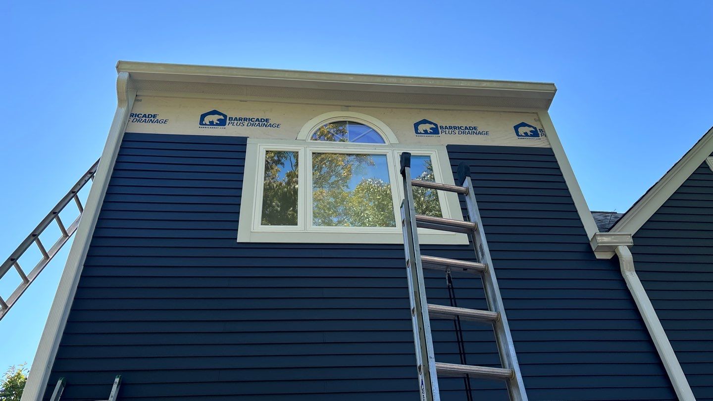 Professional energy efficient windows installation in Swampscott MA home exterior, Essex County, North Shore region during summer remodeling