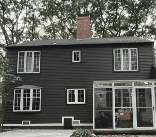 A two-story dark gray house Window Contractor Salisbury MA