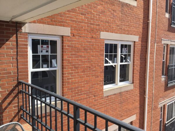 New double-hung windows were installed on this brick residential building to improve insulation and overall appearance. It’s Time to Replace Your Windows if aging windows are contributing to drafts, rising energy bills, or outdated curb appeal.