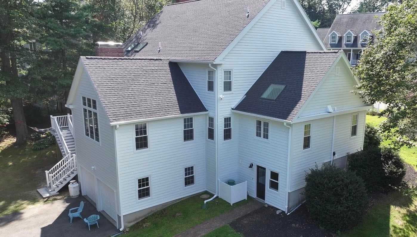Double hung windows with grids on Beverly MA home exterior showing replace your windows transformation. Harvey Tribute Windows