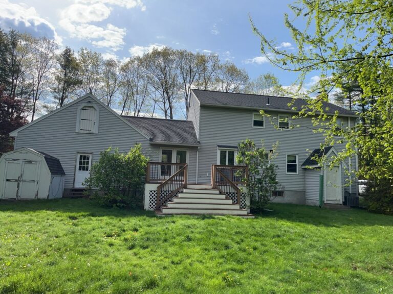 Metal roofing panels on a residential home under clear sky. Roofing in Leominster MA