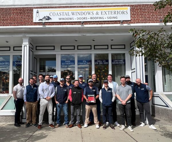 Coastal Windows & Exteriors team celebrating Top 500 Remodeler recognition outside their Beverly MA showroom.