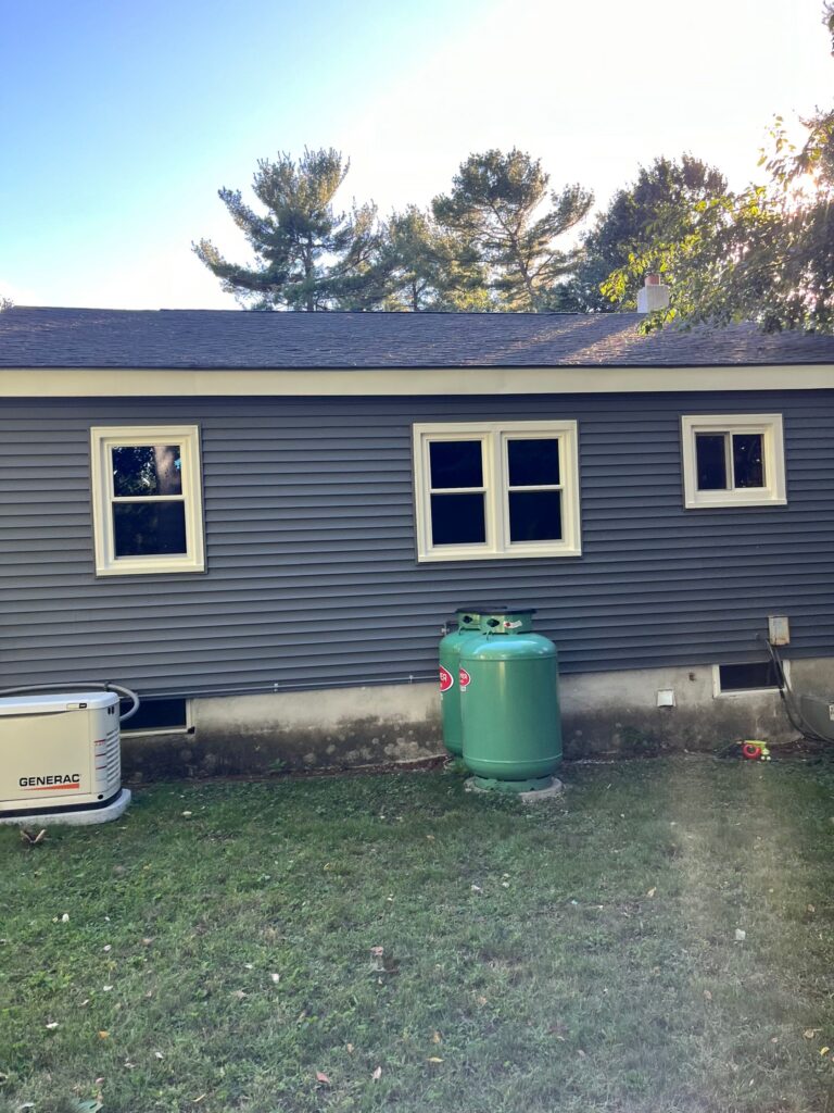 Back view of a Pelham NH home with professional window replacement in Pelham by Coastal Windows & Exteriors.