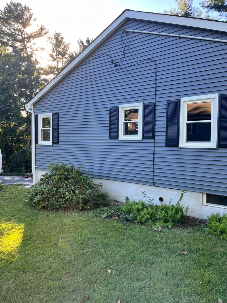 Side view of a Pelham NH home highlighting energy-efficient window replacement in Pelham by Coastal Windows & Exteriors.