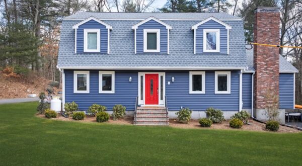 Norfolk MA home with new indigo blue vinyl siding and red entry door installed by Coastal Windows & Exteriors.