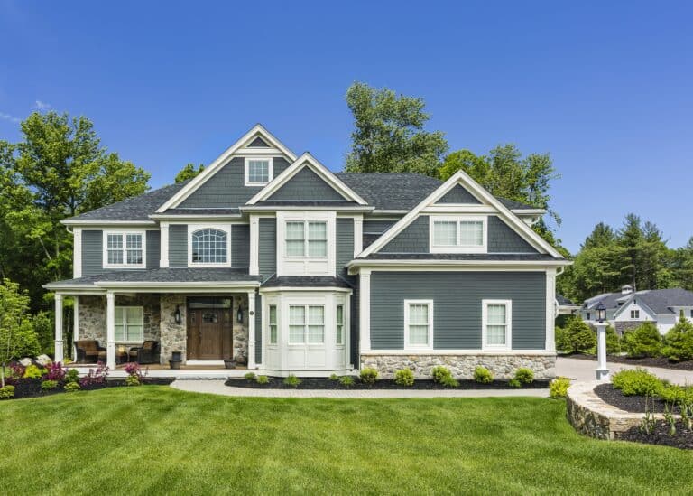 Vinyl siding replacement completed by Weare siding contractors protects this home from moisture and weather damage.