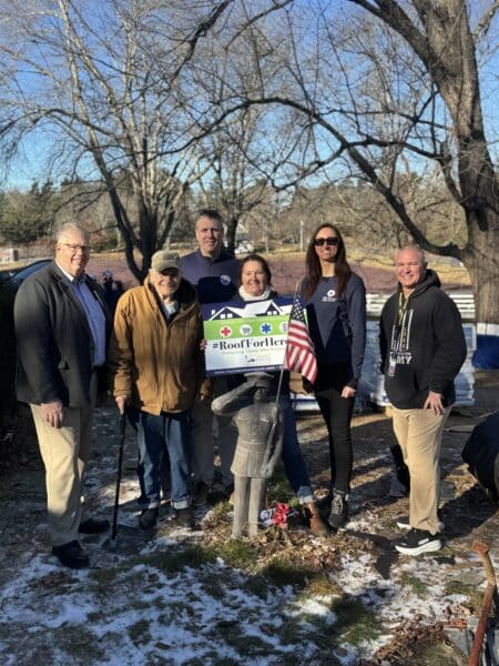 A veteran is honored by Coastal Windows & Exteriors during a Roof For Heroes event in Norfolk and Wrentham MA.