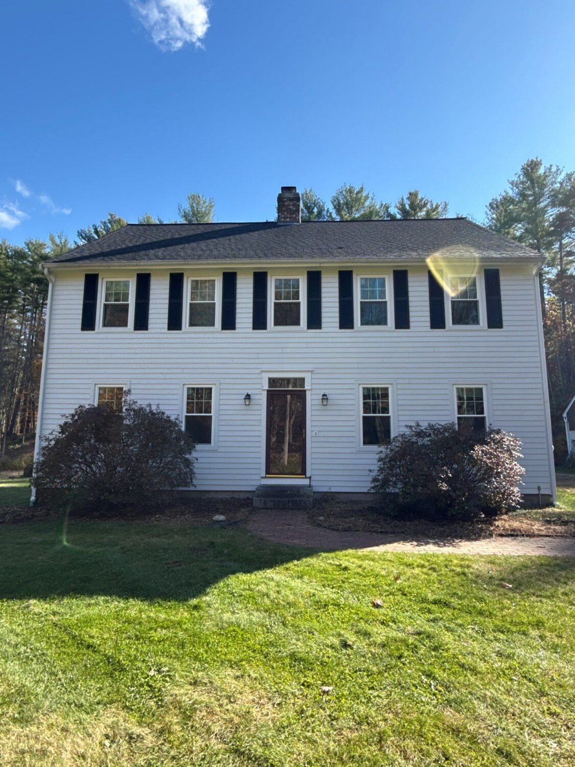 Colonial home featuring James Hardie siding that answers is it worth it to replace siding with long-lasting performance and beauty. The finished exterior combines traditional character with durable fiber cement siding.