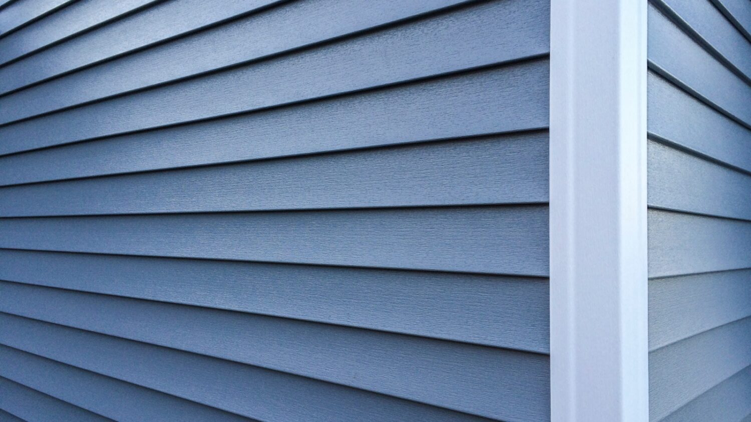 close-up of modern exterior installed by a vinyl siding company Dedham MA featuring clean lines and low-maintenance siding materials.