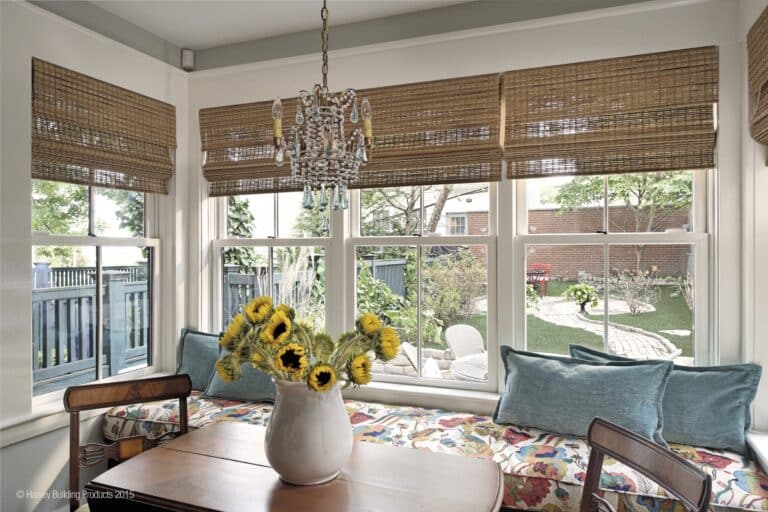modern sunroom upgraded with window replacement Dedham MA featuring insulated glass windows to eliminate drafts and improve efficiency.