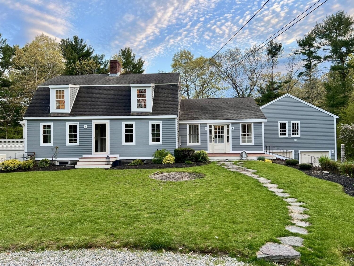 modern farmhouse transformed with durable siding by James Hardie siding contractor in Foxboro MA designed to resist moisture and rot