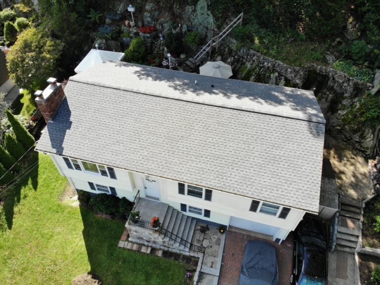 aerial view of home with new shingles installed by a Roofing contractor in Foxboro MA to prevent leaks and water damage