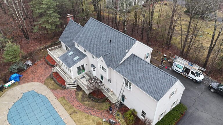 Aerial view of a newly installed roofing system designed to withstand harsh New England weather conditions. Homeowners researching how long does a roof last in Massachusetts often invest in durable roofing materials that help protect against storms, ice dams, and seasonal temperature changes.