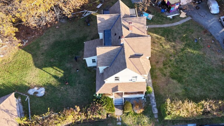 Aerial view of a roof upgrade that enhances both curb appeal and long-term home protection. Homeowners asking how long does a roof last in Massachusetts often choose modern architectural shingles that deliver durability and visual appeal.