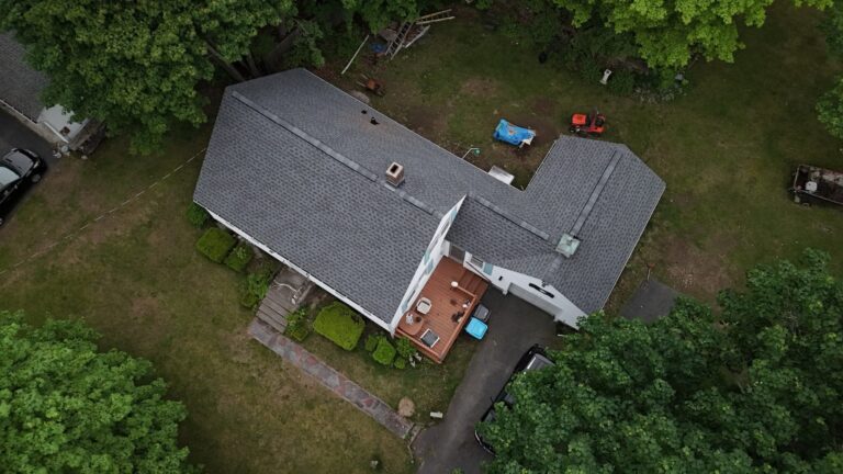 Aerial image of a home featuring a newly installed GAF Pewter Gray roof replacement in Central Massachusetts. When evaluating how long does a roof last in Massachusetts, premium asphalt shingles and expert installation play a major role in maximizing performance and longevity.