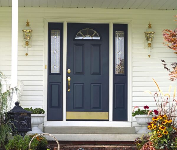 This classic black front entry door with decorative glass sidelites enhances both curb appeal and home security. Homeowners looking for a dependable door company in Wolfeboro NH can rely on Coastal Windows & Exteriors for expertly installed replacement entry doors.